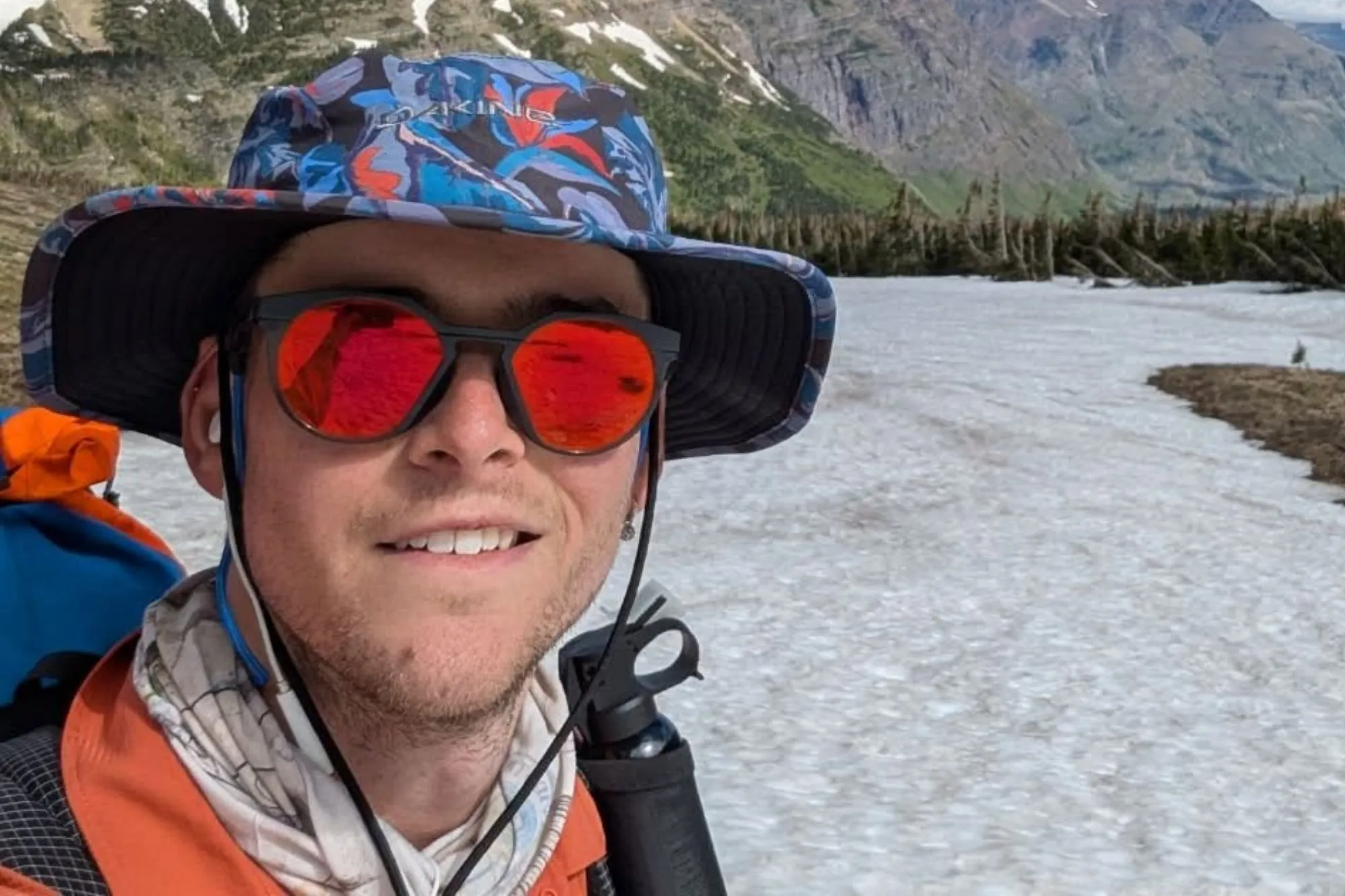 An image collage containing 1 images, Image 1 shows Will Standish, a hiker, smiling with mountains and snow in the background
