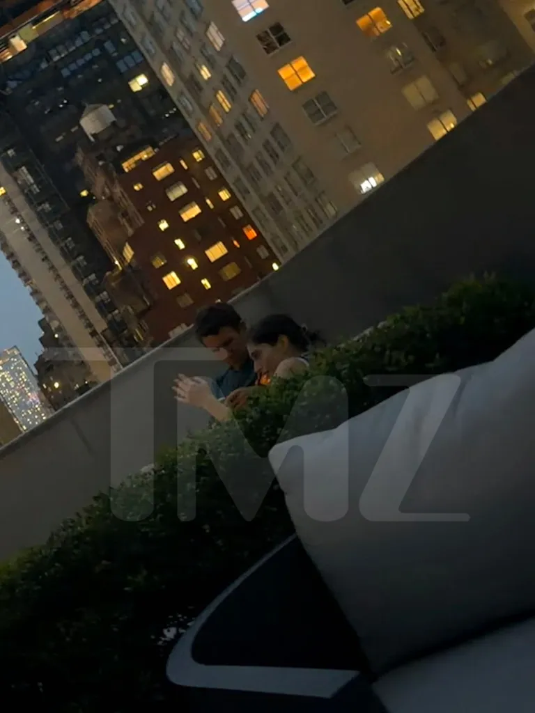 Patrick Clancy and Rachel Danis sitting on a rooftop patio in New York City.