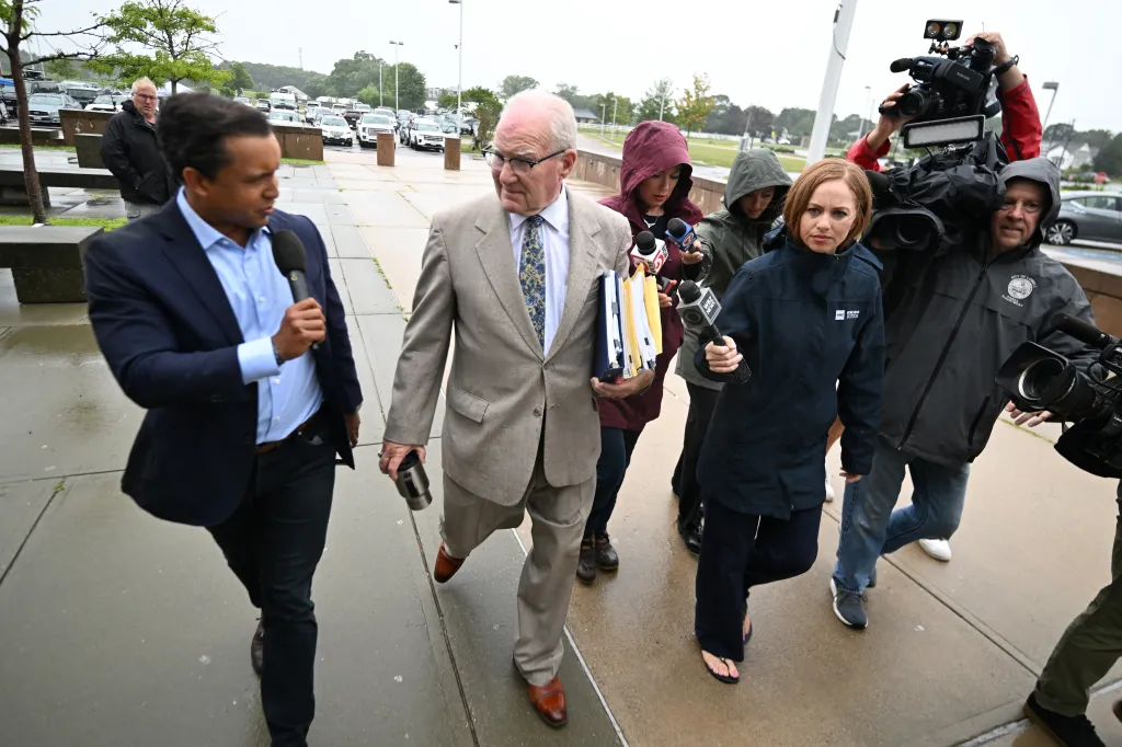 Lawyer Kevin Reddington, defending Clancy, is flanked by reporters as he arrives at Plymouth Superior Court on Friday, Aug. 21, 2026, in Plymouth, Mass.