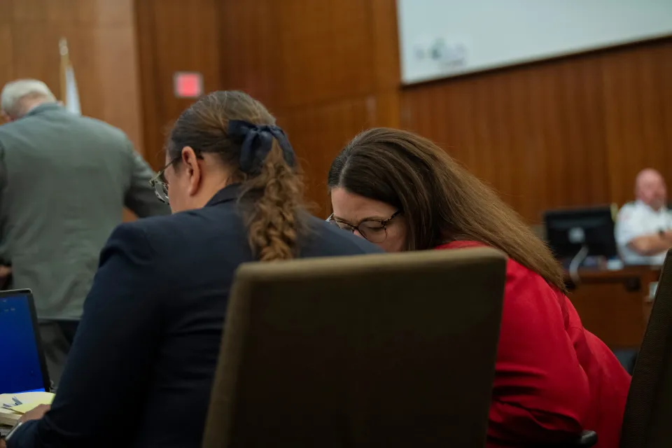 Prosecutor Jennifer Sprague (right) talks to fellow prosecutor Shanan Buckingham during a murder trial.