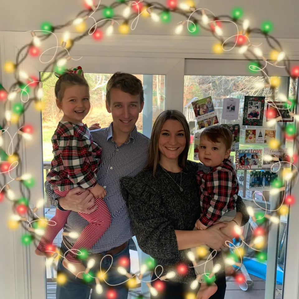 A family portrait of Lindsay Clancy, her husband, and two of their three children, with Christmas lights superimposed around the border.