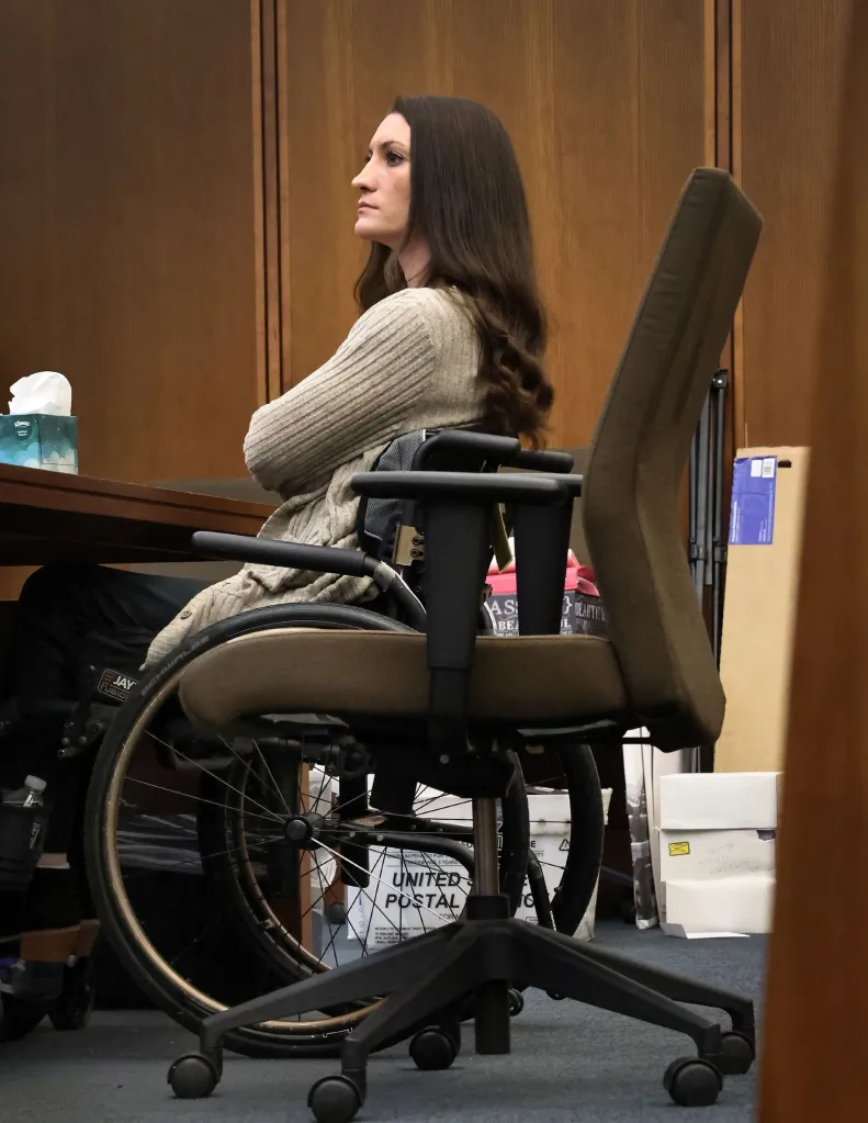 Lindsay Clancy in a wheelchair, listening to testimony at her murder trial.